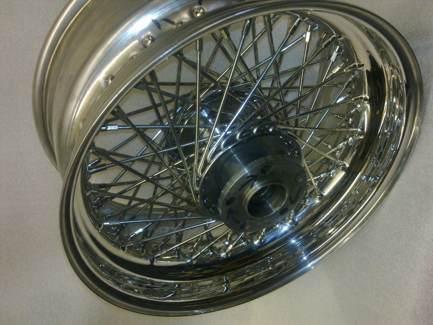 Polished spoked motorcycle wheel